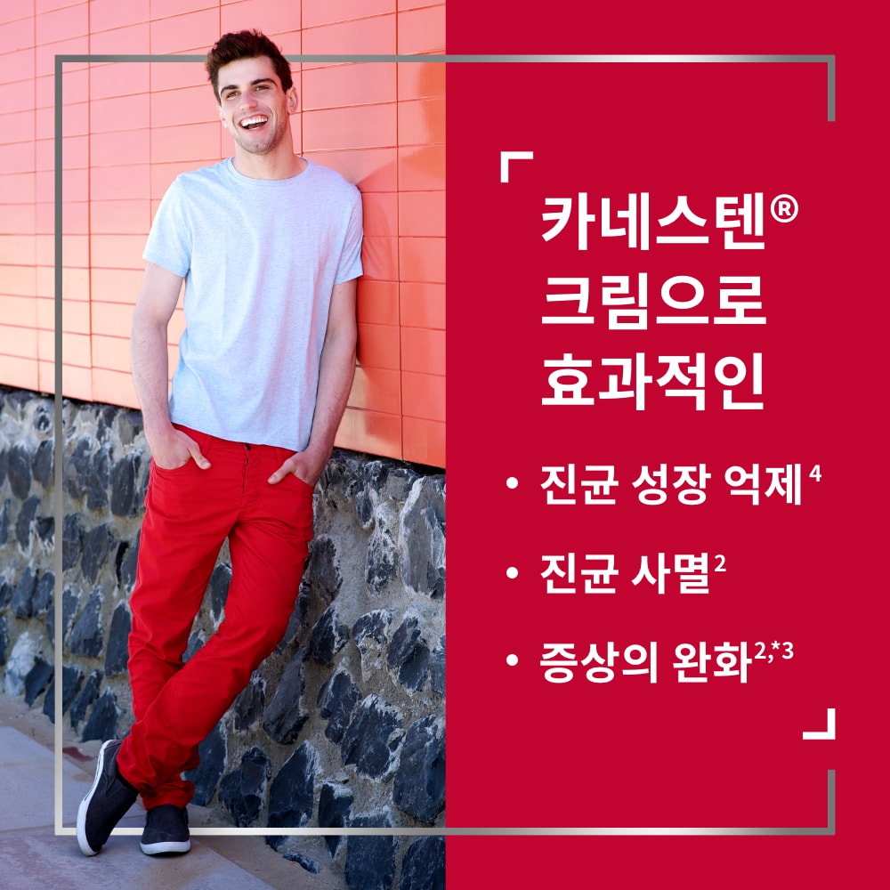 Happy young man with hands in pockets leaning against wall